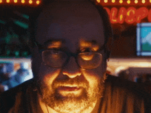 a man with glasses and a beard screams in front of a sign that says liquor