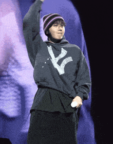 a person wearing a hoodie with the letter k on it