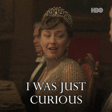 a woman wearing a tiara says i was just curious in front of a hbo logo