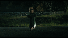 a car is driving down a road at night and a person is flying through the air