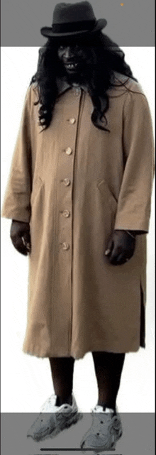 a man wearing a long coat and a hat