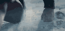a close up of a person 's foot walking in the snow .