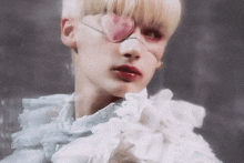 a close up of a person 's face with a pink heart on their eye
