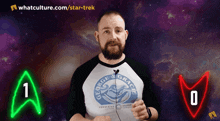 a man wearing a shirt that says george & gracie stands in front of a green and red star trek symbol