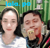 a man singing into a microphone next to a woman with the words lala po written on the bottom