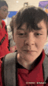 a close up of a boy 's face with a watermark that says ' minimx ' on it