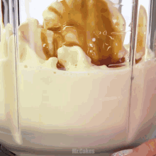 a blender filled with ice cream and caramel sauce with the words mr.cakes above it