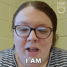 a woman wearing glasses says i am with her mouth open