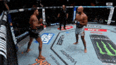 two men in a boxing ring with ads for bud light