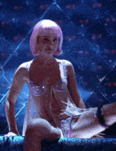 a woman with pink hair is sitting on a bench