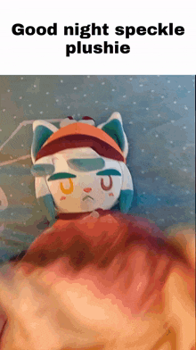 a stuffed animal is laying on a bed with the words good night speckle plushie below it
