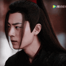 a close up of a man 's face with chinese characters on the bottom right