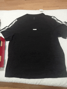 a black t-shirt with the word puma on it