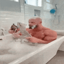 a shirtless man is taking a bath in a bathtub