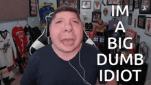 a man wearing headphones and a shirt that says i 'm a big dumb idiot on it