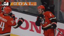 a hockey player wearing a red jersey with the number 24 on it