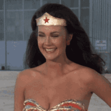 a woman wearing a crown with a red star on it is smiling