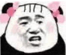 a panda bear wearing a pink bow on his head .