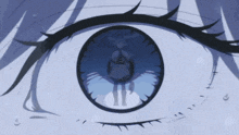a close up of a person 's eye with a reflection of a woman in it
