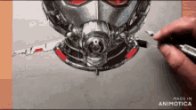 a person is drawing an ant man with a pencil