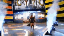 a woman is standing on a stage in front of a sign that says lucky lynch .