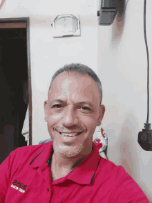 a man wearing a red shirt that says 2208 on the front