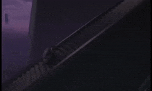 a dark staircase with a purple sky in the background