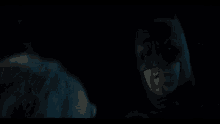 a close up of a person 's head in the dark with blue hair .