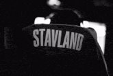 a black and white photo of a person 's back with the name stavland on it