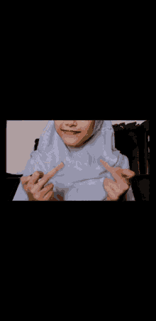 a person making a heart shape with their fingers