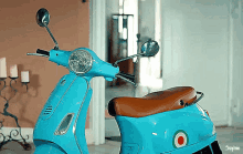 a blue vespa scooter is parked in a hallway