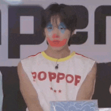 a man wearing a white sleeveless shirt with the word poppop on it .