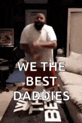 a man in a white shirt and red shorts is dancing in a living room .