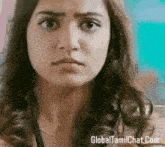 a close up of a woman 's face with the website globaltamilchat.com visible in the corner