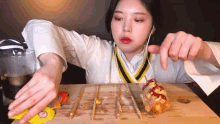 a woman is eating a bunch of food on a wooden table