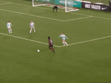 a soccer game is being played on a field with ads for desjardins and west