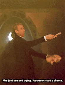 a man in a suit is pointing at something with the words five foot one and crying below him