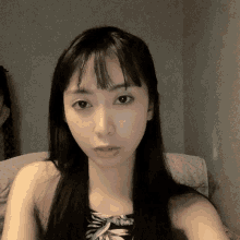 a woman with long black hair is taking a picture of herself