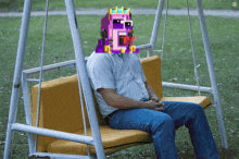 a man is sitting on a swing with a pixelated face on his face