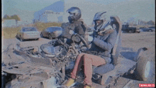 a man and a woman are sitting in a wrecked vehicle with the words we 'll be back written on the bottom