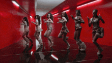 a group of women are dancing in a hallway