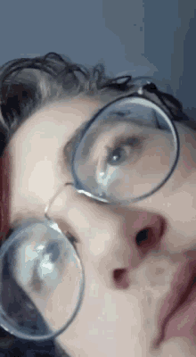 a close up of a person 's face with glasses