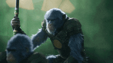 a blue monkey holding a spear with a gold emblem on it