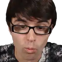 a man wearing glasses and a tie dye shirt is making a funny face