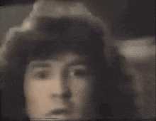 a close up of a person 's face with a surprised look on his face .