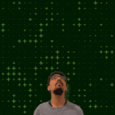 a man with glasses stands in front of a green background with the number 10 on it