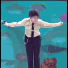 a man in a suit and tie is holding a microphone
