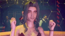 a man with long hair is dancing in a club while wearing a woman 's dress .