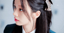 a close up of a woman 's face with a hair clip in her hair that says fendi