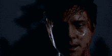 a close up of a man 's face covered in blood